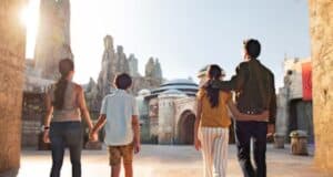 A family walking through Star Wars: Galaxy's Edge at Disneyland.