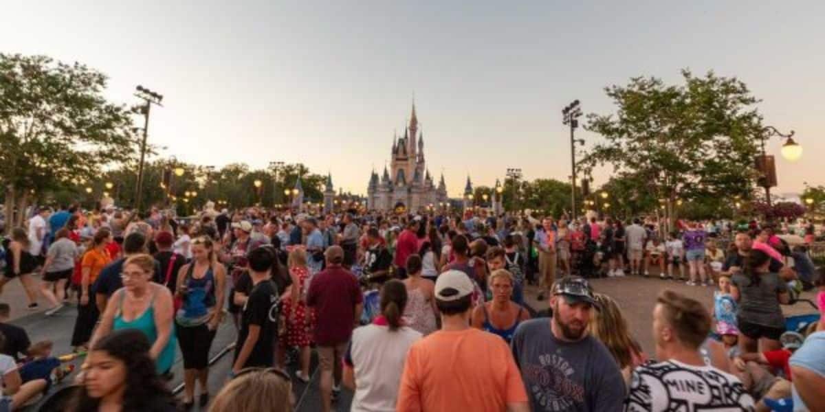 A large crowd in Walt Disney World Resort's Magic Kingdom with Cinderella Castle in the background