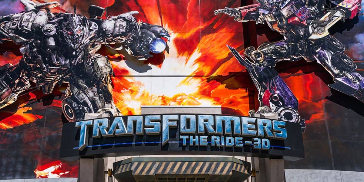 Entrance to "Transformers: The Ride 3D" featuring large, dramatic murals of Autobots