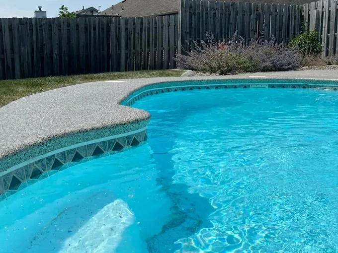 Duration Concrete Coatings by Duralast shows a well-made pool deck, perfect for relaxing and enjoying the outdoors.