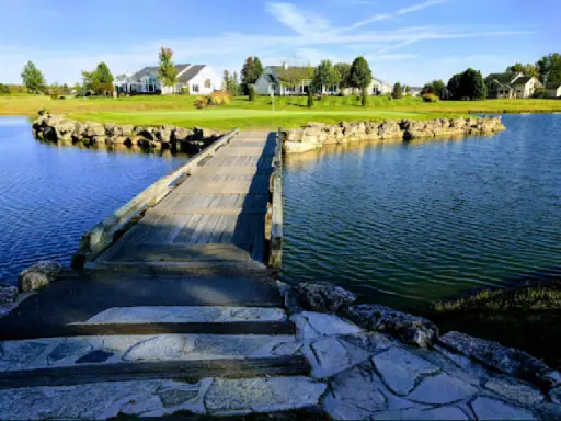 Homes with neat lawns, possibly updated by Duration Concrete Coatings by Duralast, sit in a peaceful neighborhood setting.
