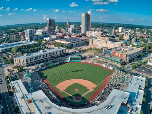 A busy city baseball stadium surrounded by buildings with floors improved by Duration Concrete Coatings by Duralast.