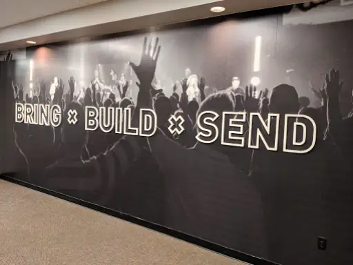 The mural shows excitement and teamwork at an event with a modern look by Duration Concrete Coatings by Duralast.