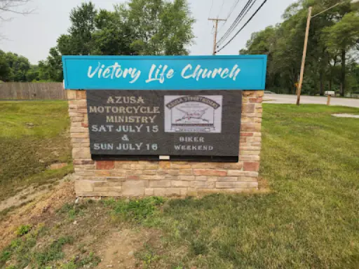 Event sign at Victory Life Church shares info on a biker weekend and highlights Duration Concrete Coatings by Duralast.