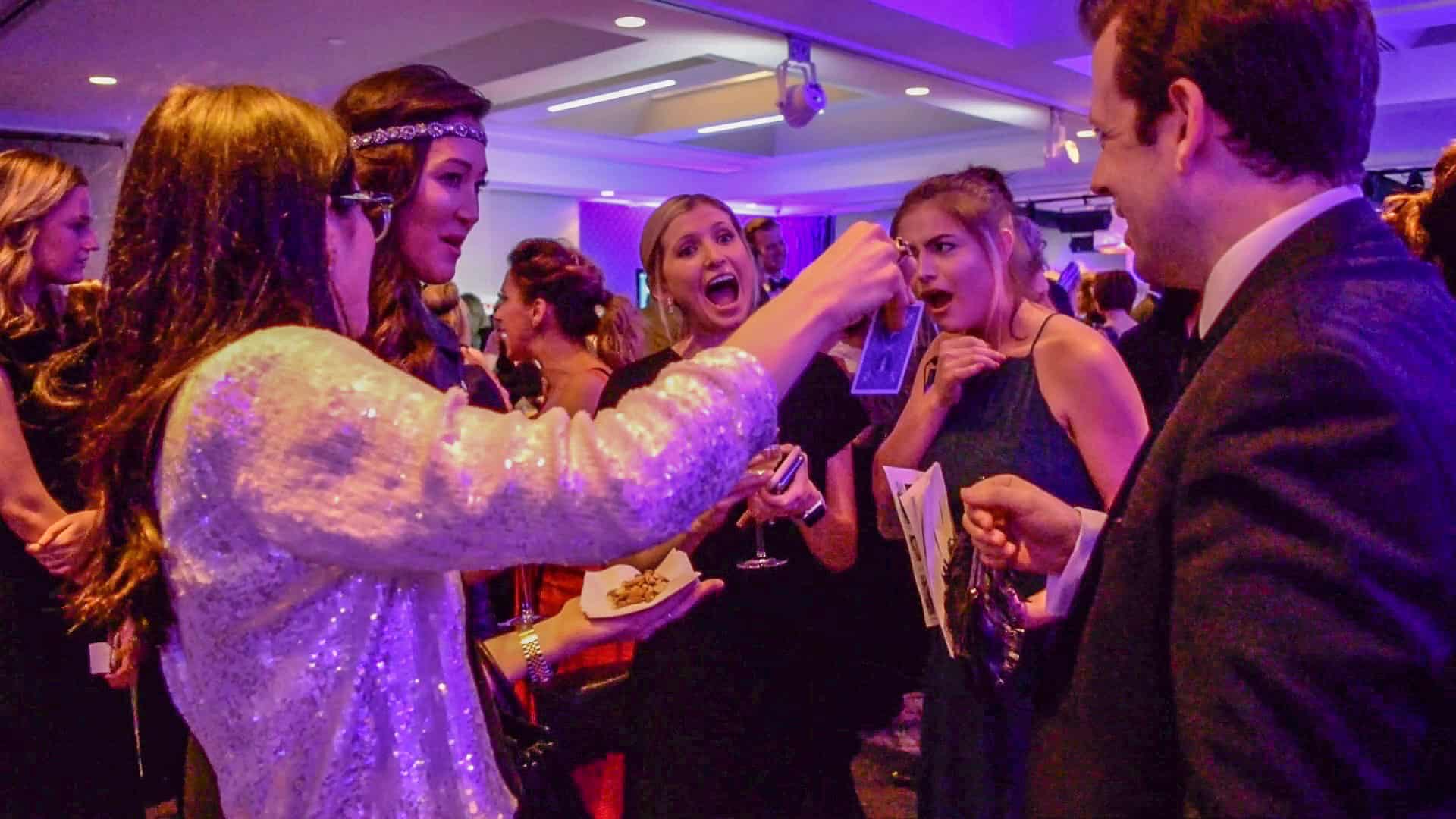Magician facilitating conversations and interactions at a networking reception.