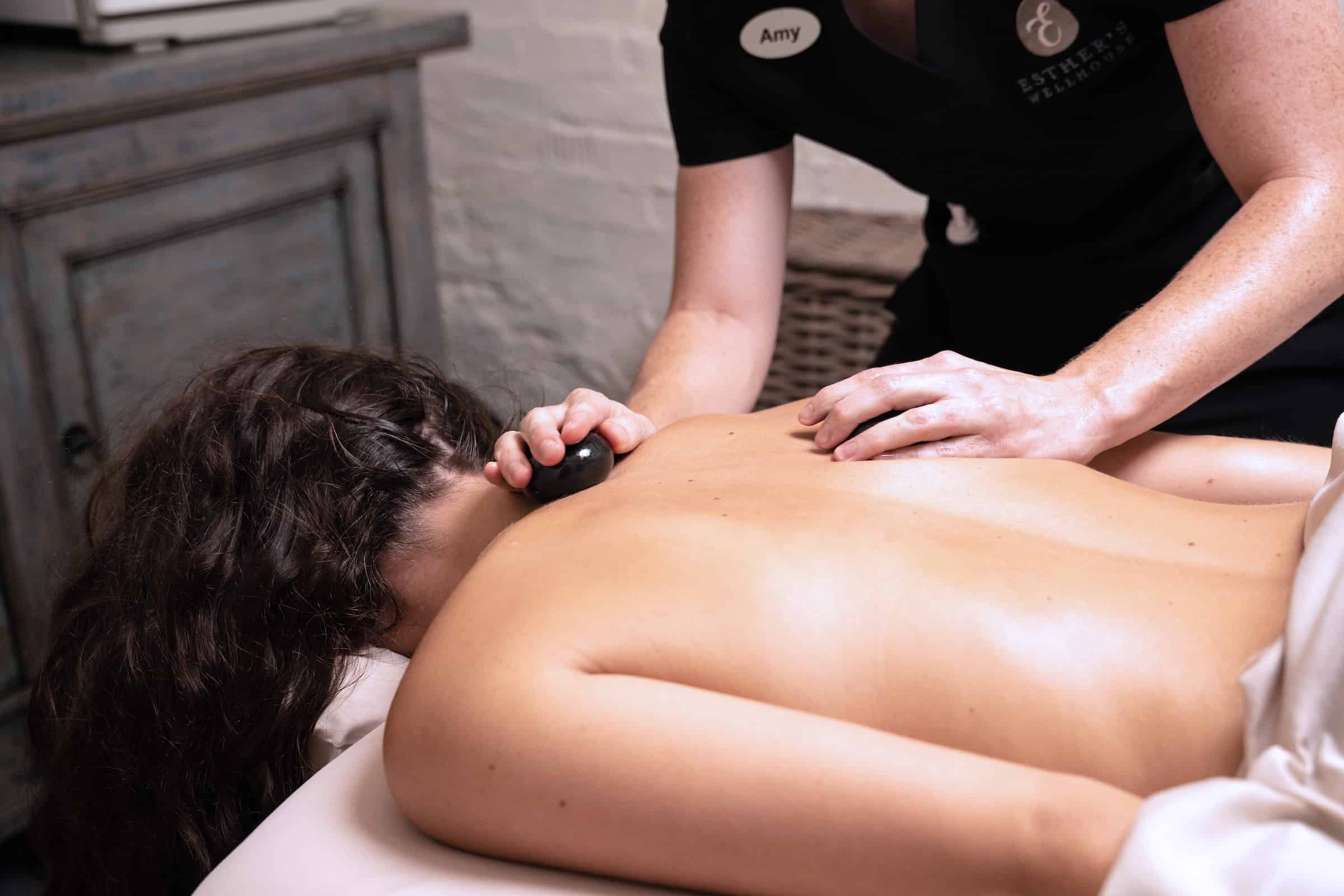A woman getting a hot stone massage
