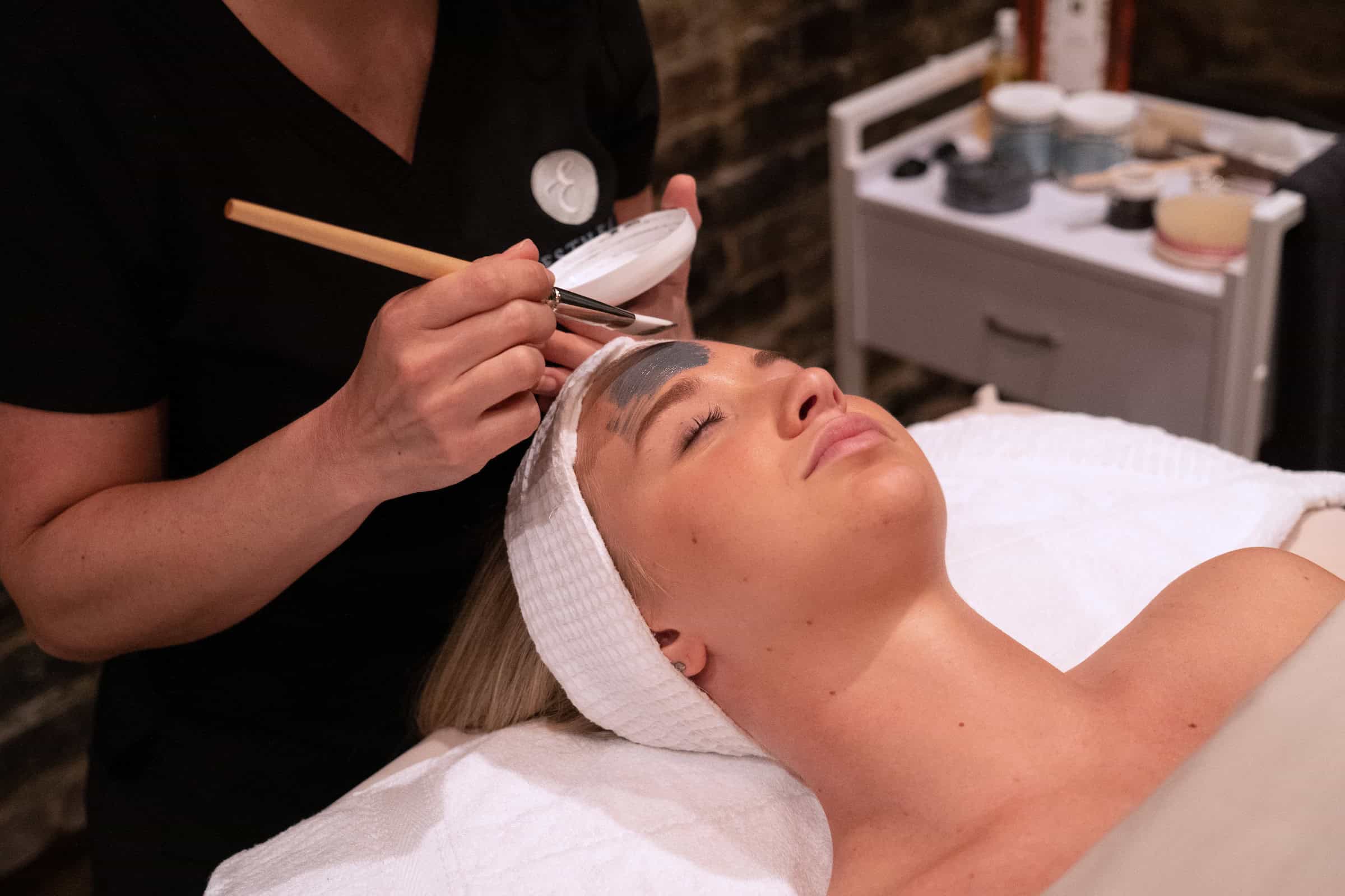 A woman receiving a classic facial