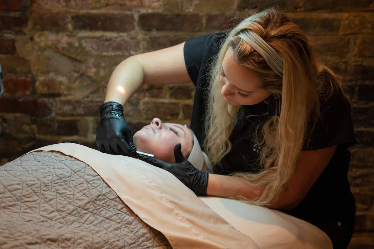 A client receiving a dermaplaning treatment