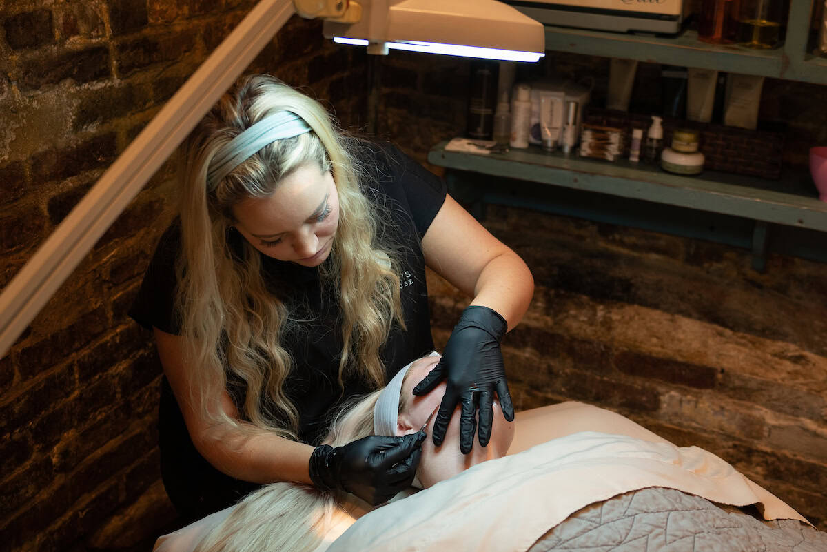 A client receiving a dermaplaning treatment