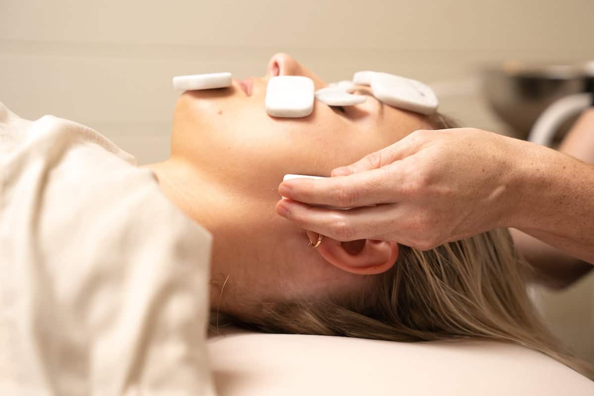 a woman receiving a cod stone massage
