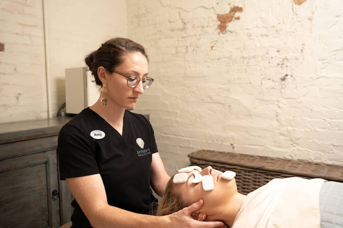 a woman receiving a cod stone massage