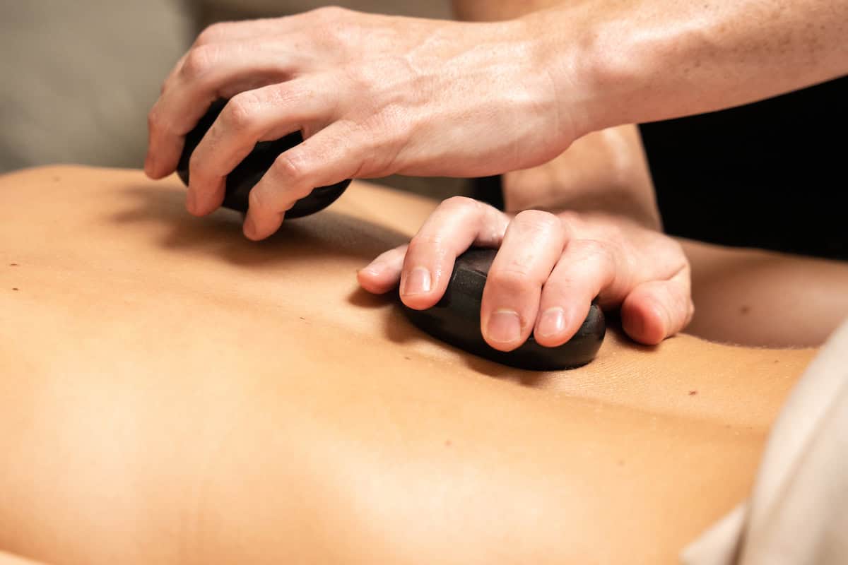 hot stone massage on a back