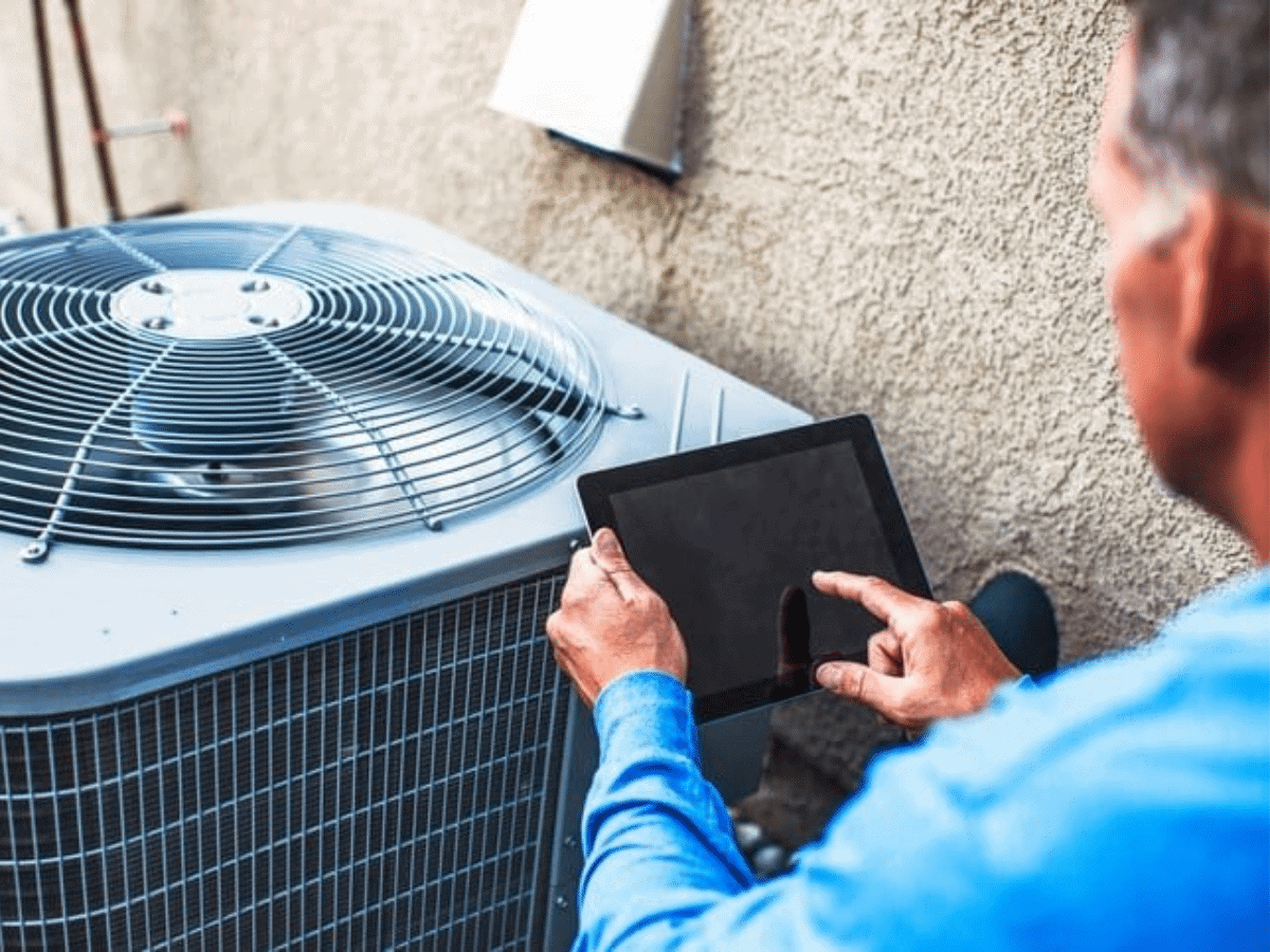 technician checking on ac unit for the summer
