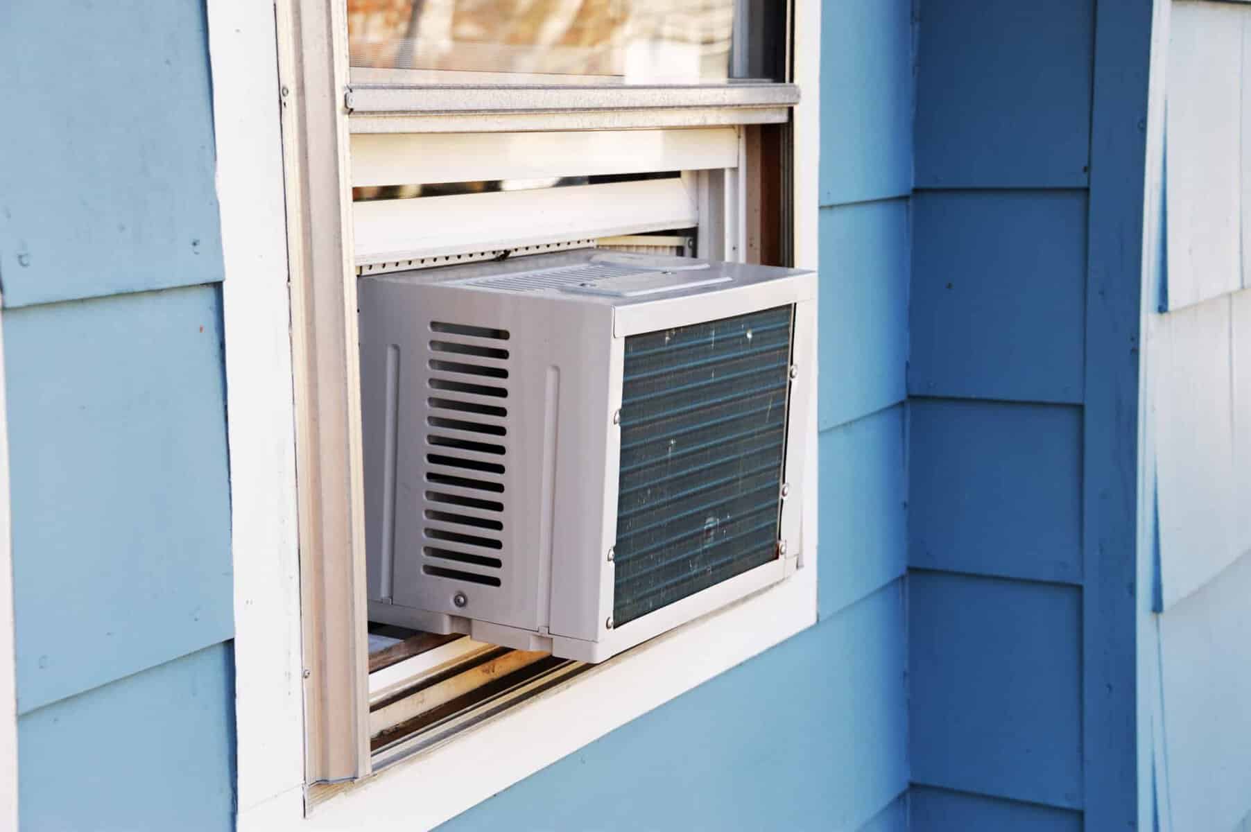 Navigating a summer heatwave becomes manageable with our window air conditioner unit, seamlessly installed in a blue-painted wall. Perfect for those considering AC replacement and essential questions about efficiency and style.