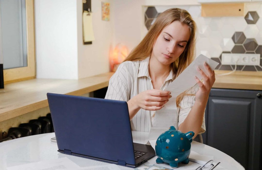 Woman checks sales receipt after shopping. Returning goods, calculating costs, planning own budget