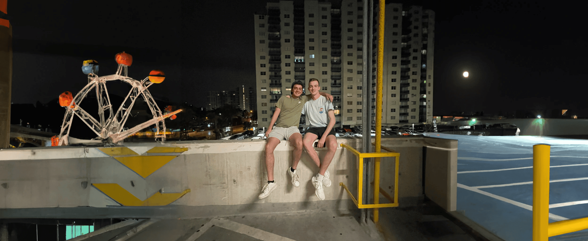 two men sitting on a parking lot seat, with inpainting and outpainting features from DALL-E 2 used