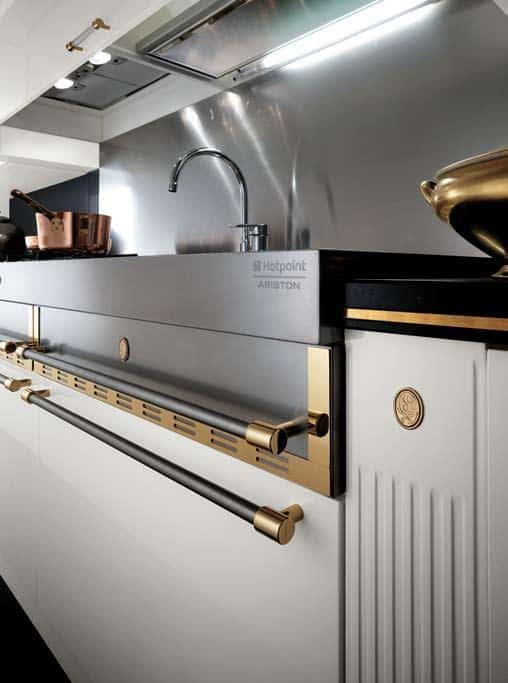 Luxury kitchen with stainless steel appliances, gold accents, and a modern sink.