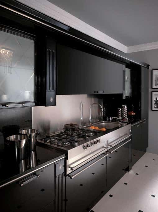 Sleek modern kitchen with black cabinetry, stainless steel appliances, and a polished countertop, featuring a gas stove and minimalist decor.