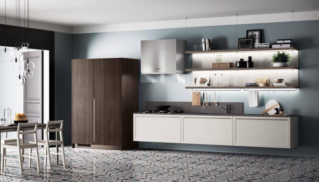 Modern kitchen with a sleek design, featuring hanging shelves, minimalistic cabinets, a patterned floor, and a dining area with chairs and a dark table.