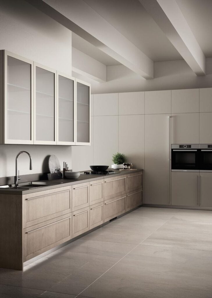 Modern kitchen with minimalist design, featuring light wood cabinets, integrated appliances, and a sleek countertop with built-in sink and stove.