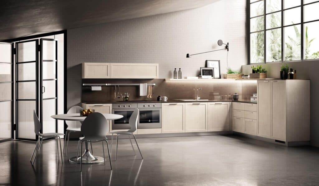 Modern kitchen with light wood cabinets, a round dining table with four chairs, large windows, and minimalistic decor.