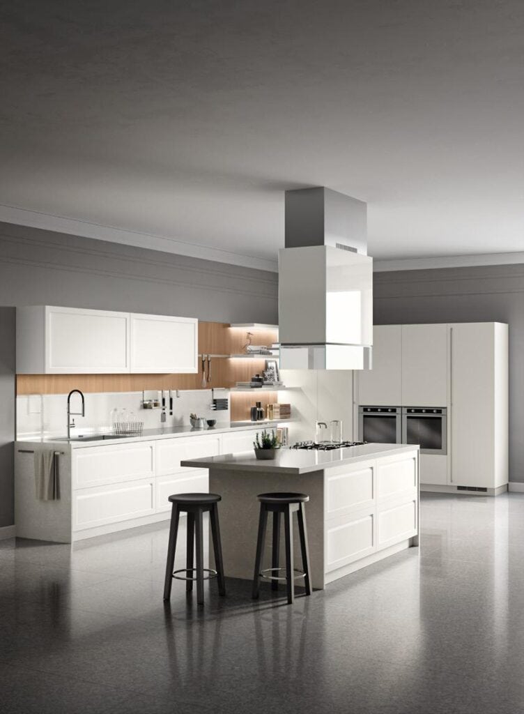 Modern kitchen with white cabinetry, a central island with bar stools, built-in ovens, and a range hood.