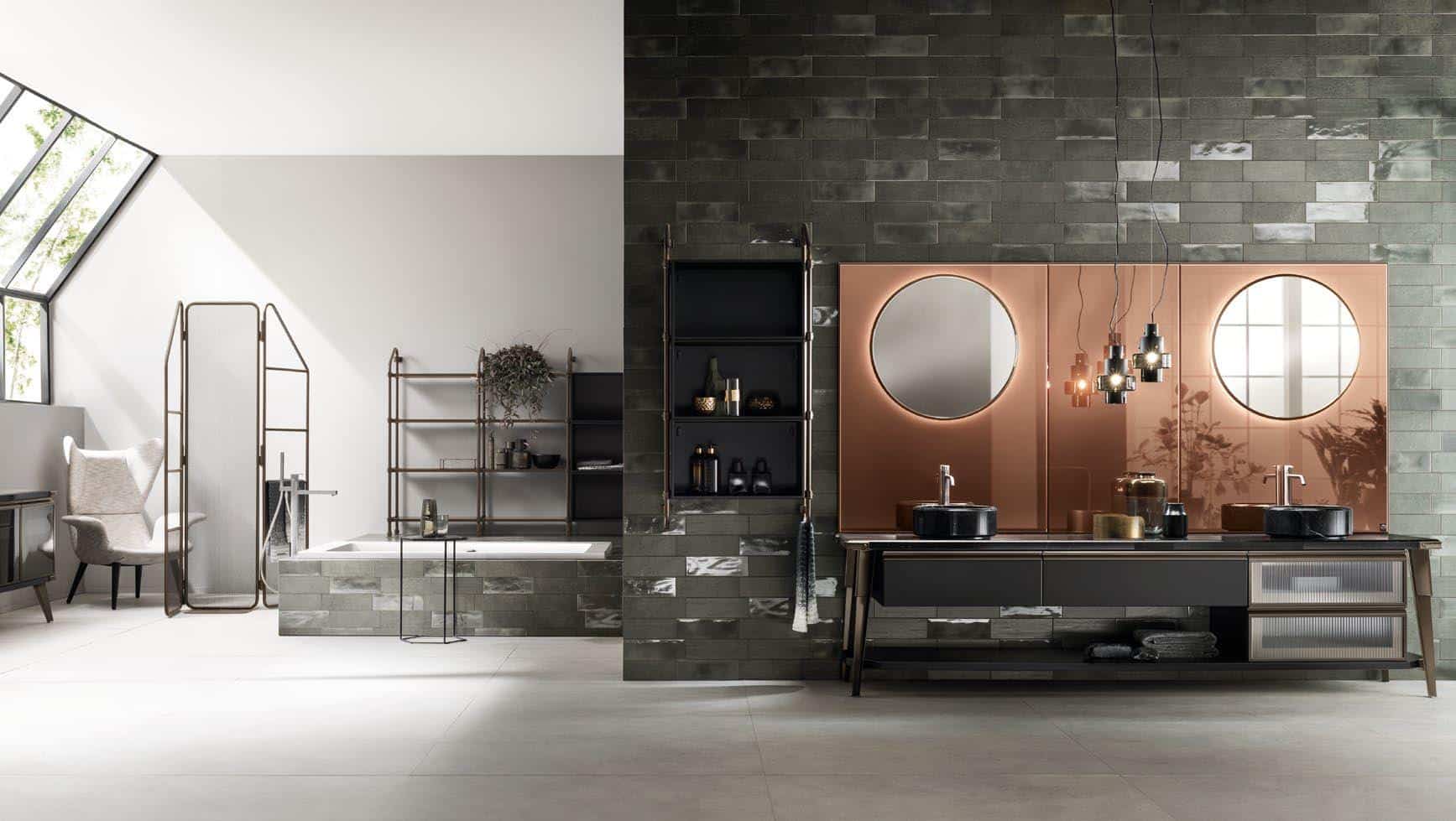 Modern bathroom interior with dark tiled walls, large vanity with dual sinks and round mirrors, a bathtub, shelving, and a chair under angled skylights.
