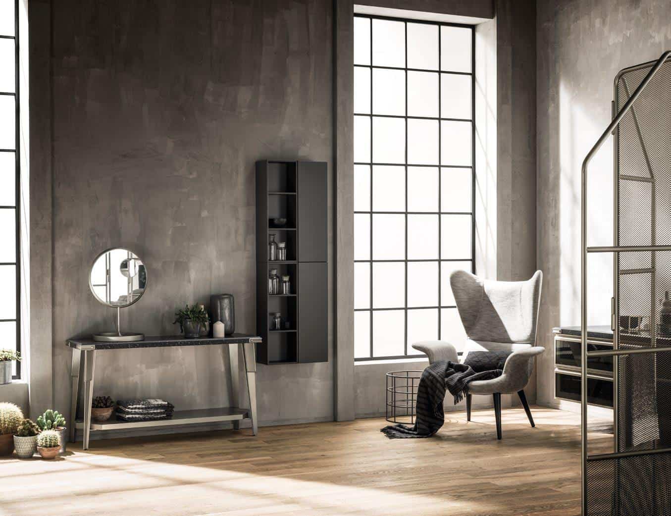 Modern industrial interior with large windows, a wingback chair, a console table with a mirror, and potted plants on a wooden floor.