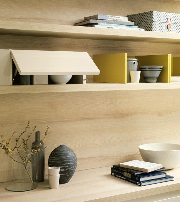 Wooden shelves with assorted decorative items, including vases, books, a small house-shaped object, and a bowl.