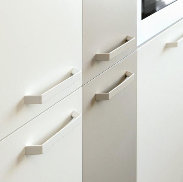 A close-up of a modern kitchen cabinet with stainless steel handles.
