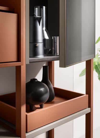 Modern shelving unit with decorative black vases and a coffee maker.
