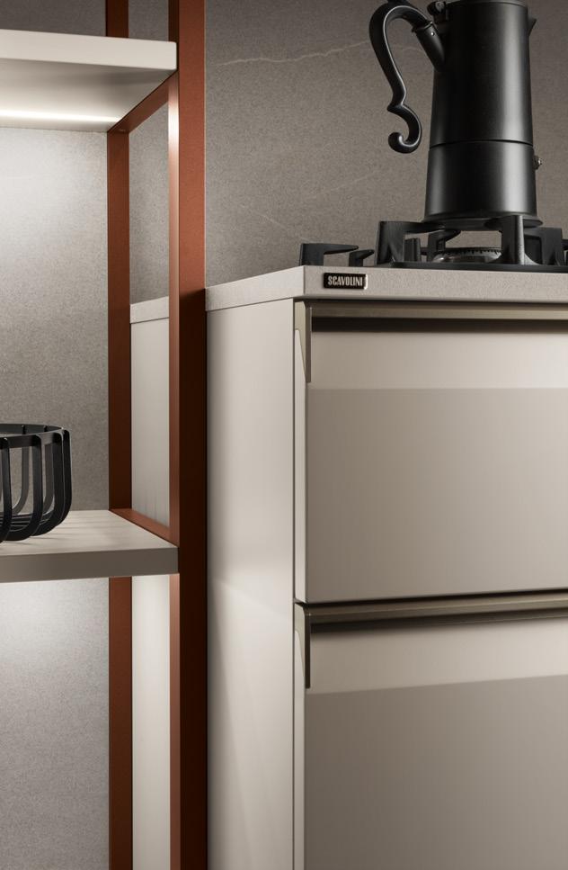 A modern kitchen with beige cabinetry, a black stovetop coffee maker, and open shelving with metallic accents.