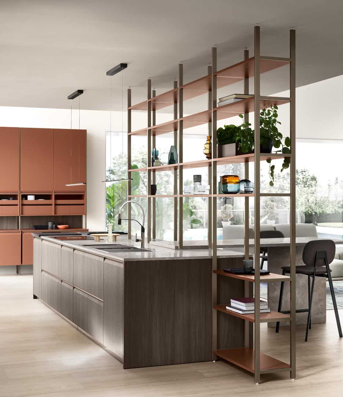Modern kitchen interior with an island, open shelving, plants, and earth-toned cabinets.