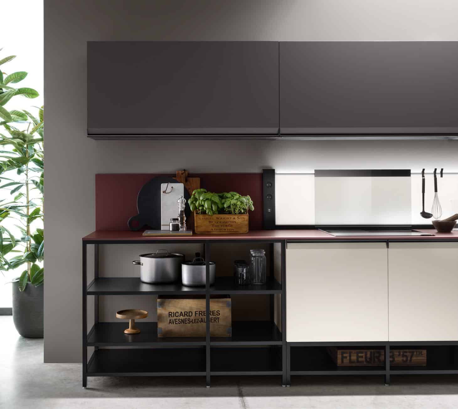 Modern kitchen interior with open shelving, cookware, plants, and minimalistic design.
