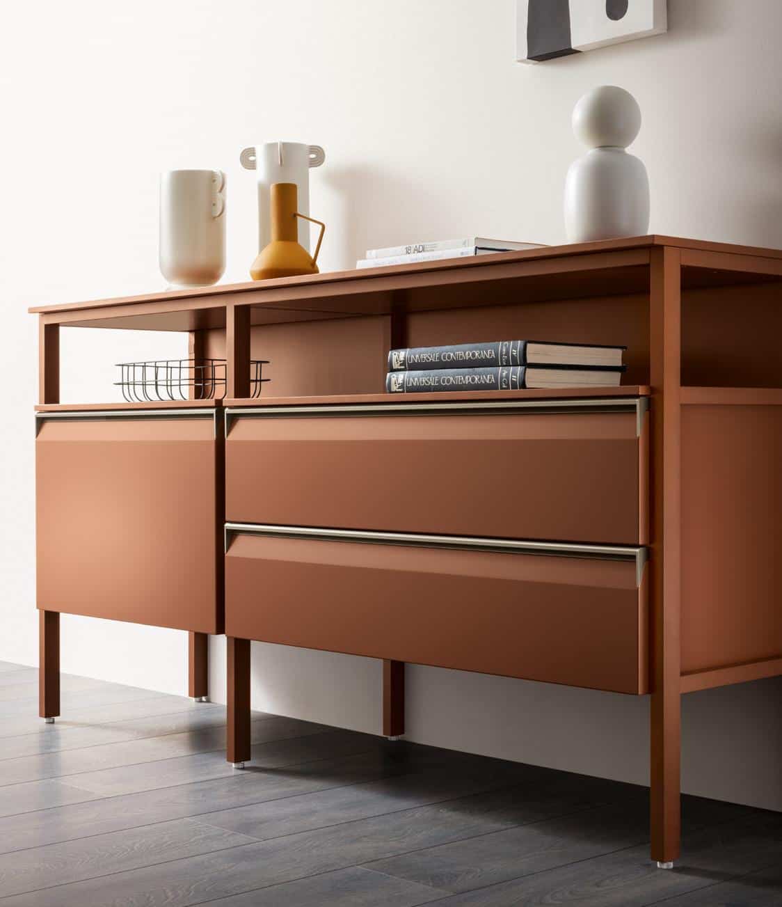 Brown modern sideboard with decorative vases and books on top, on a dark wooden floor.
