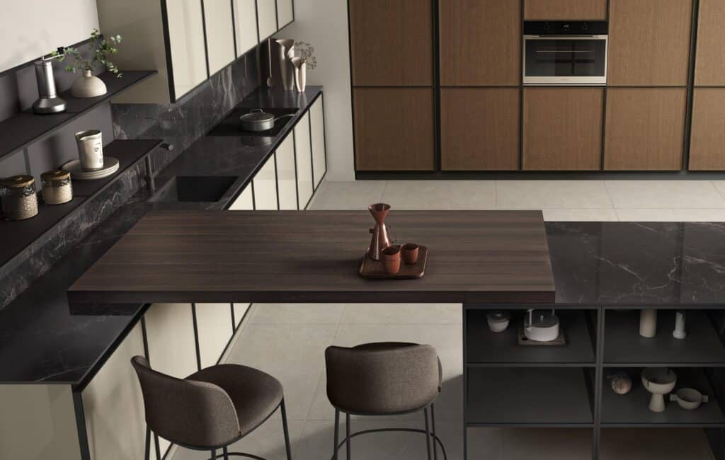Modern kitchen with dark marble countertops, wooden cabinetry, a wooden dining bar, and minimalist decor.