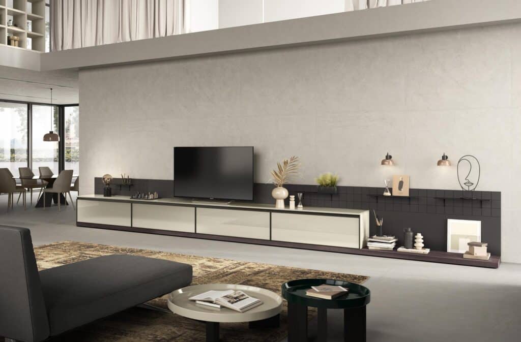 Modern living room with a sleek TV unit, minimalist decor, and a dining area in the background.