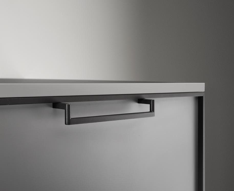 Close-up of a gray cabinet drawer with a modern black handle.