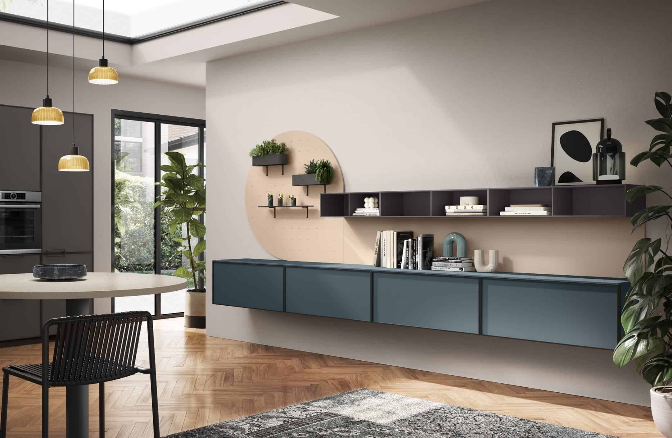 Modern living room interior with blue cabinets, open shelving, plants, and a circular wall feature.