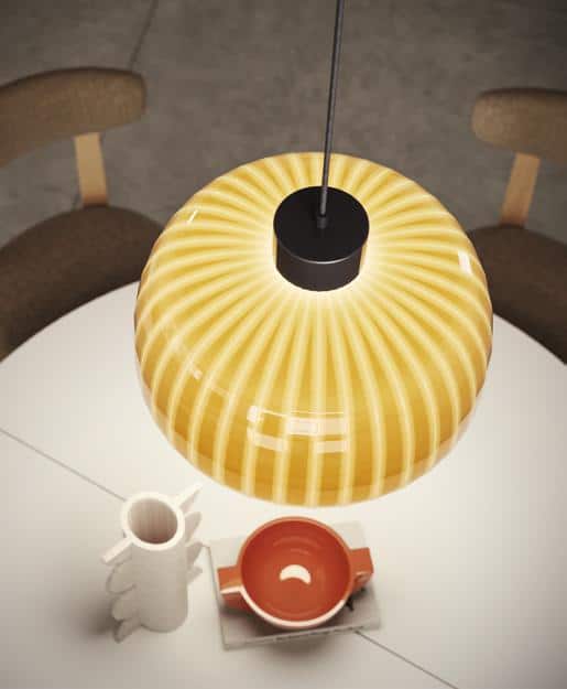 Hanging striped yellow lamp over a round white table with a pitcher and bowl.