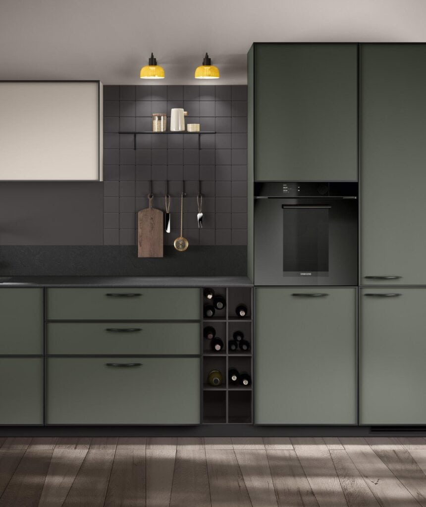 Modern kitchen with olive-green cabinets, black tiled backsplash, built-in oven, wine storage, and wooden flooring.