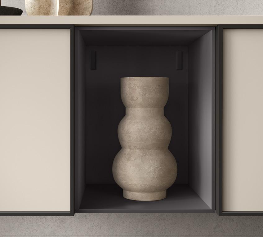 A textured beige vase with a curvy shape is placed in a recessed shelf against a dark background.