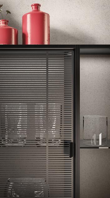 Glass cabinet with frosted striped doors, containing transparent vases and red bottles on top.