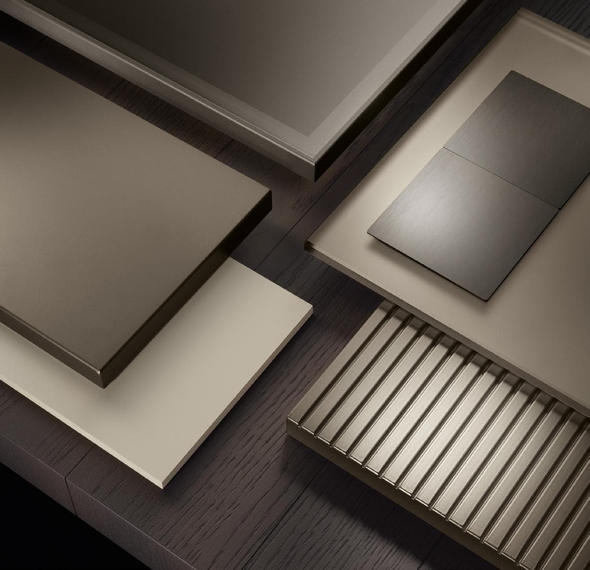 Abstract arrangement of metallic and flat surfaces in various earthy tones.