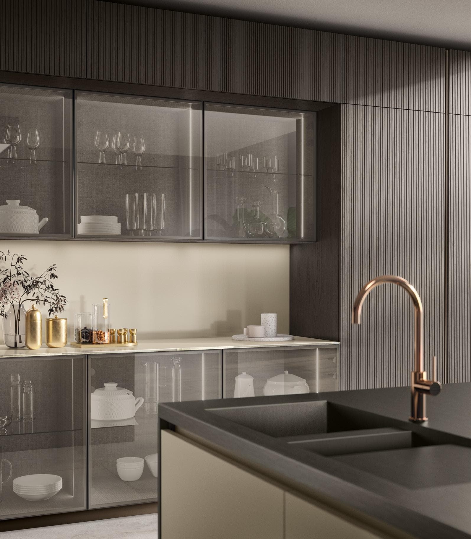 Modern kitchen interior with dark cabinetry, glass upper cabinets, a sleek gray countertop, and a copper faucet.