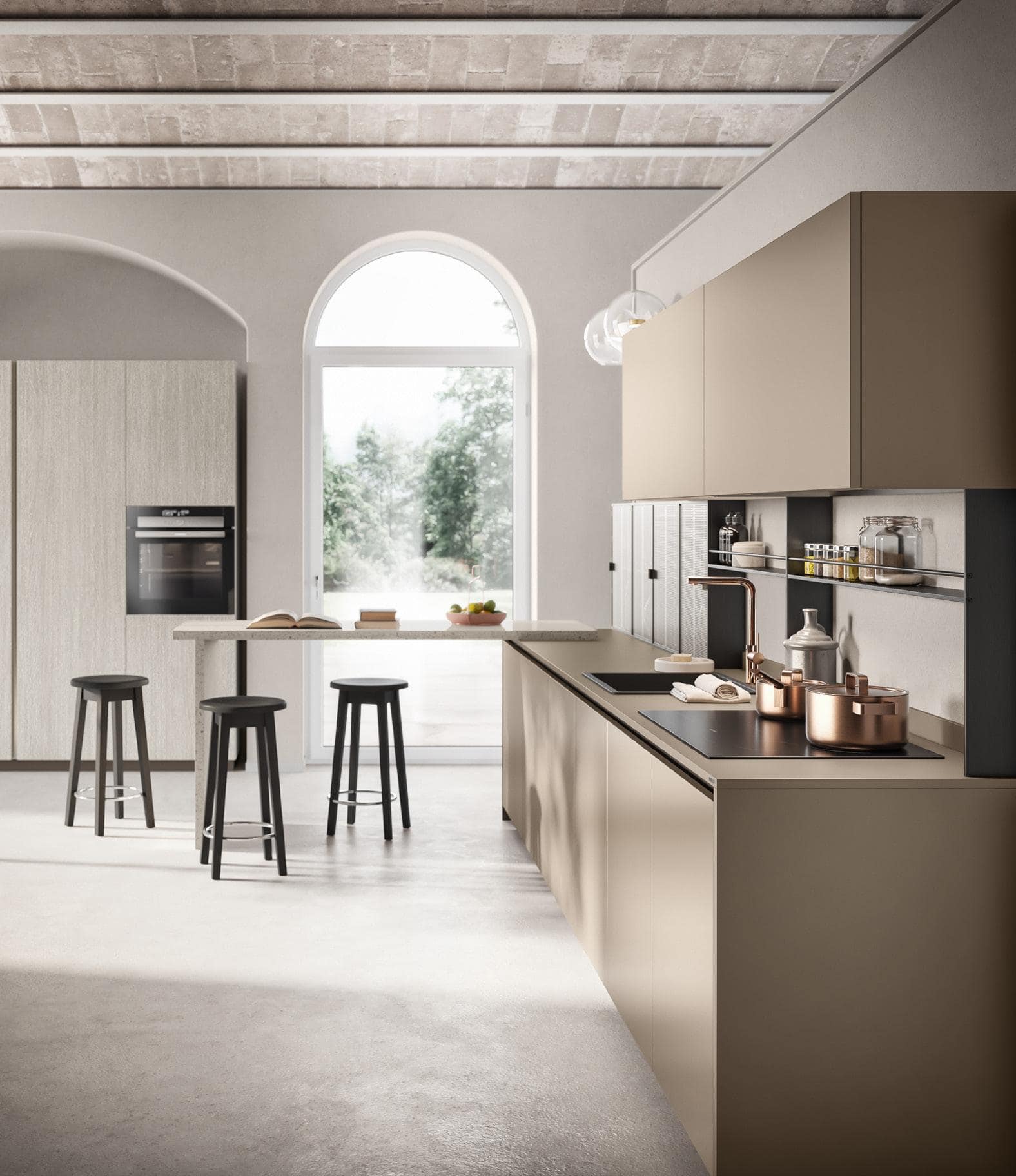 Modern kitchen with beige cabinetry, built-in oven, three black bar stools, and natural light from an arched window.