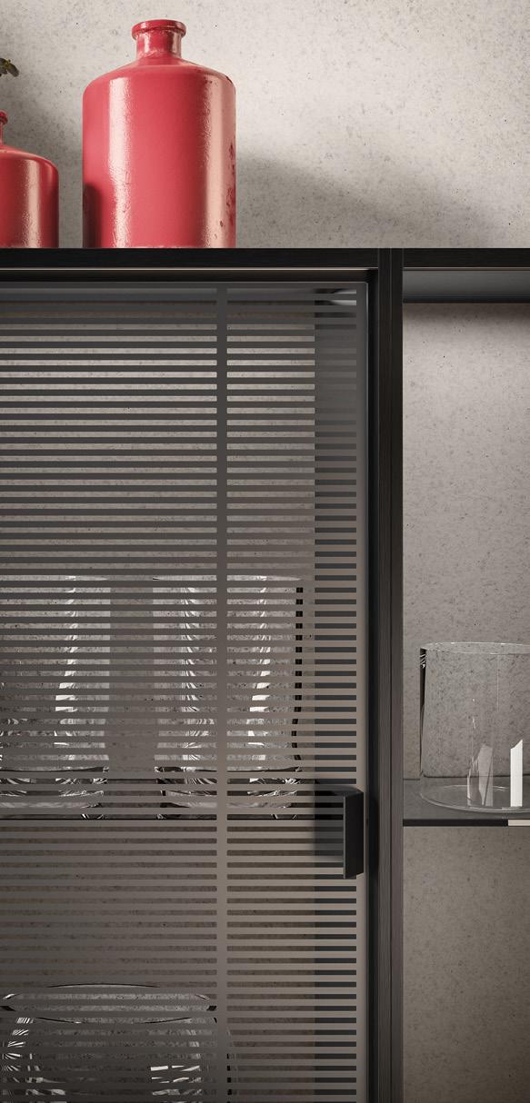 Glass cabinet with horizontal stripe pattern, containing glassware, and red ceramic vases on top.