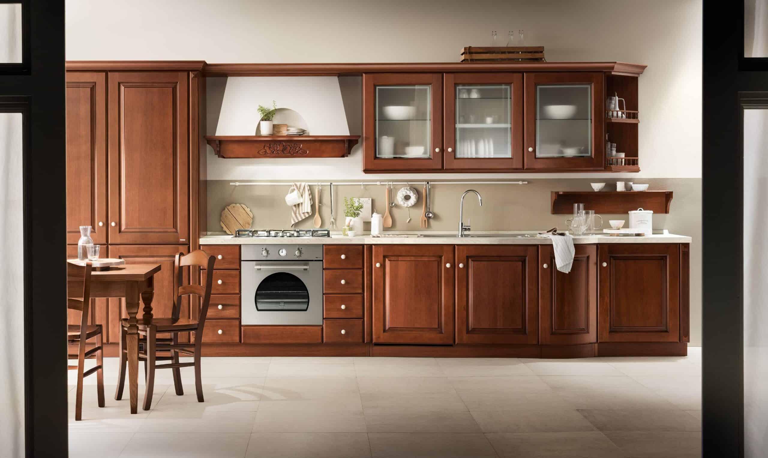 Traditional kitchen with wooden cabinets, a gas stove, and a dining table with chairs.