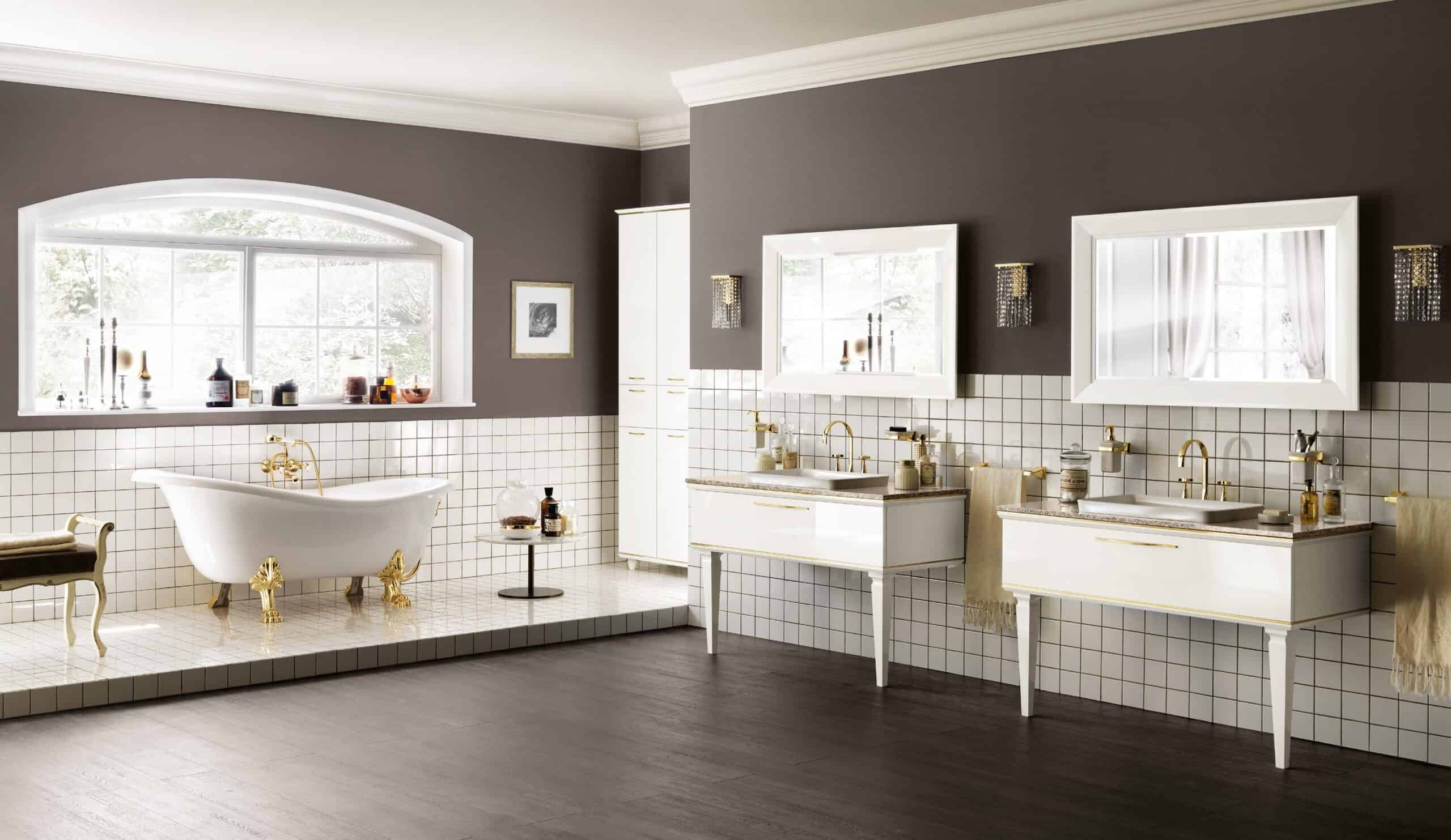 Luxurious bathroom with a freestanding clawfoot bathtub, two modern vanities with mirrors, tiled walls, and large window.