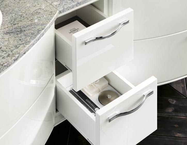 White bathroom cabinet with two open drawers, featuring a marble countertop and chrome handles.